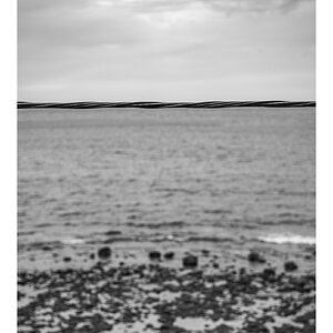fotografo-mar-rocas-cielo-cable-acero-blanco-negro.jpg